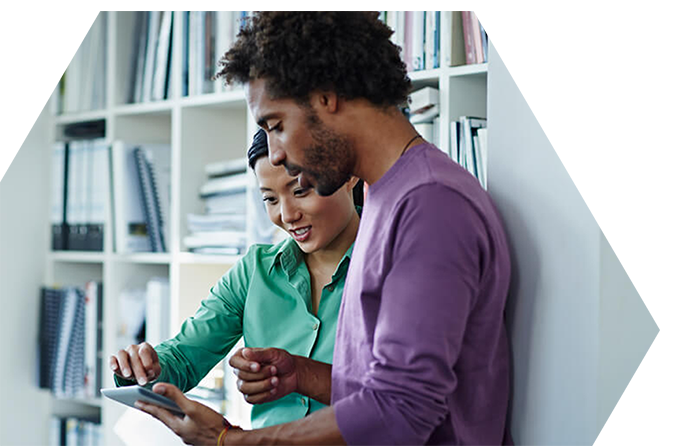 Two colleagues working at a laptop