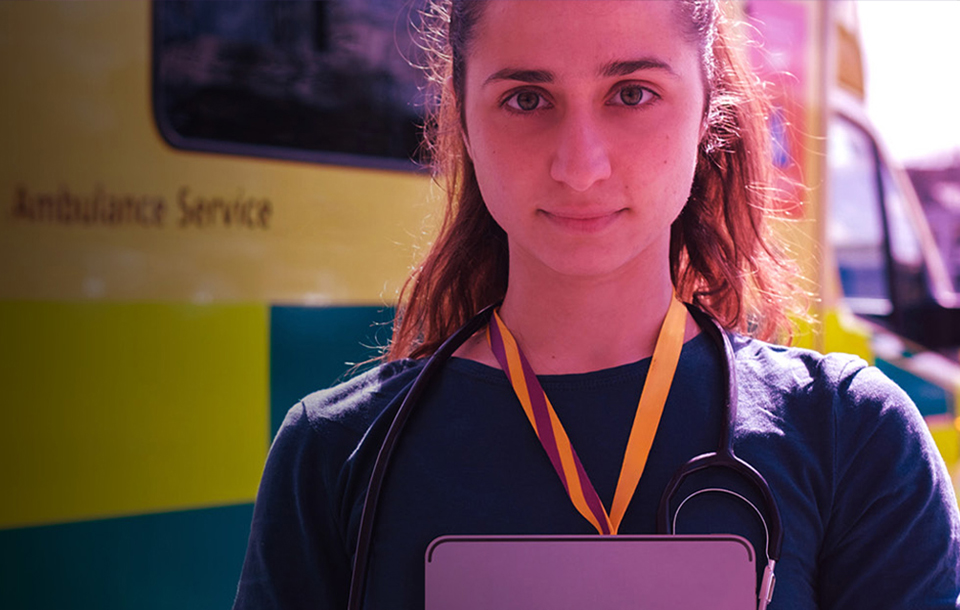 Doctor standing in front of an ambulance Doctor standing in front of an ambulance
