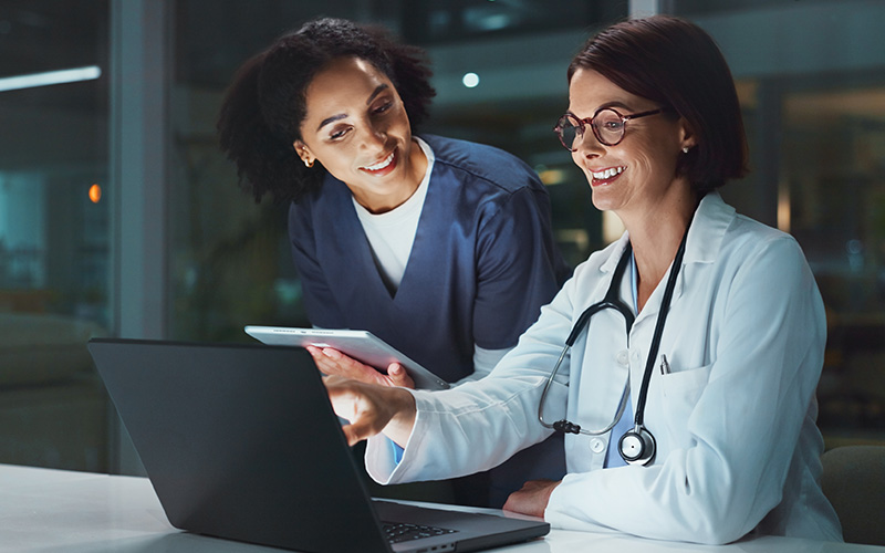 Doctors working on laptop