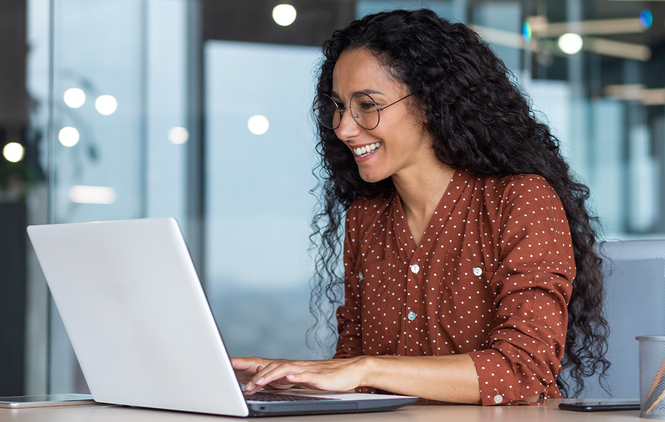Smiling woman working on laptop Smiling woman working on laptop