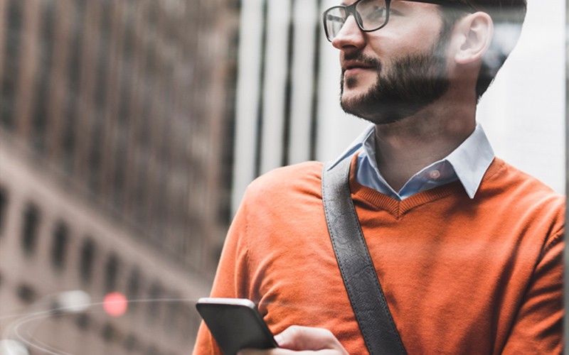 Dell EMC cloud computing Man holding phone in the city