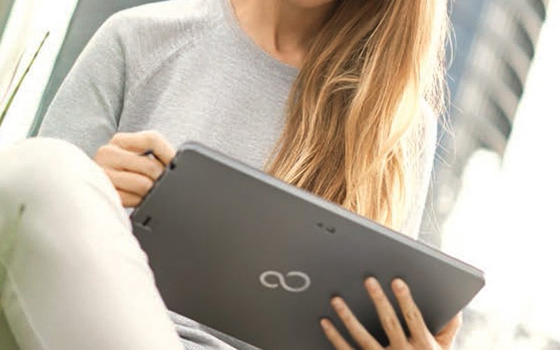 Student holding a Fujitsu tablet