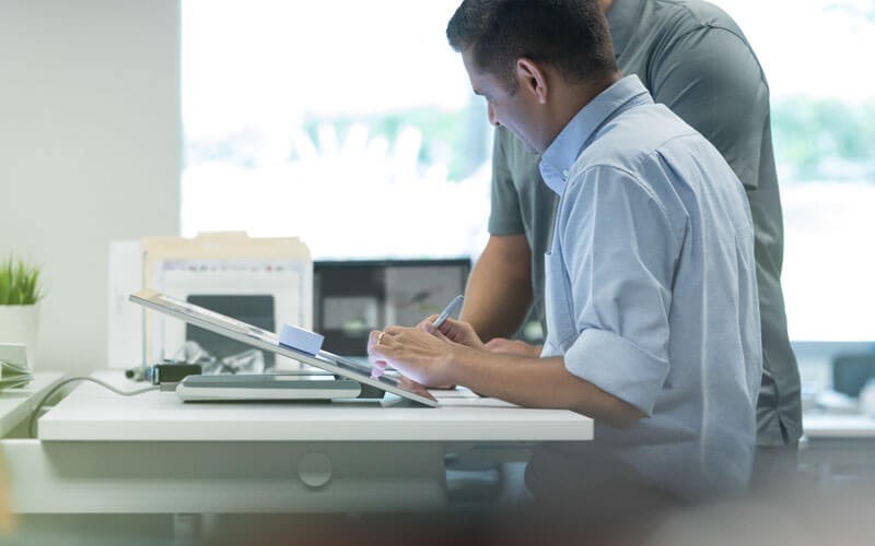 Microsoft Hardware Solutions Microsoft businessman working on Surface Studio device