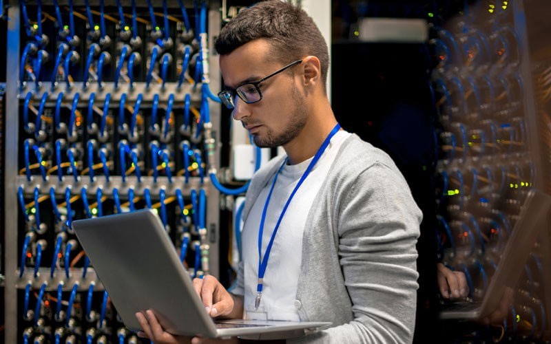 Young man working in a data centre